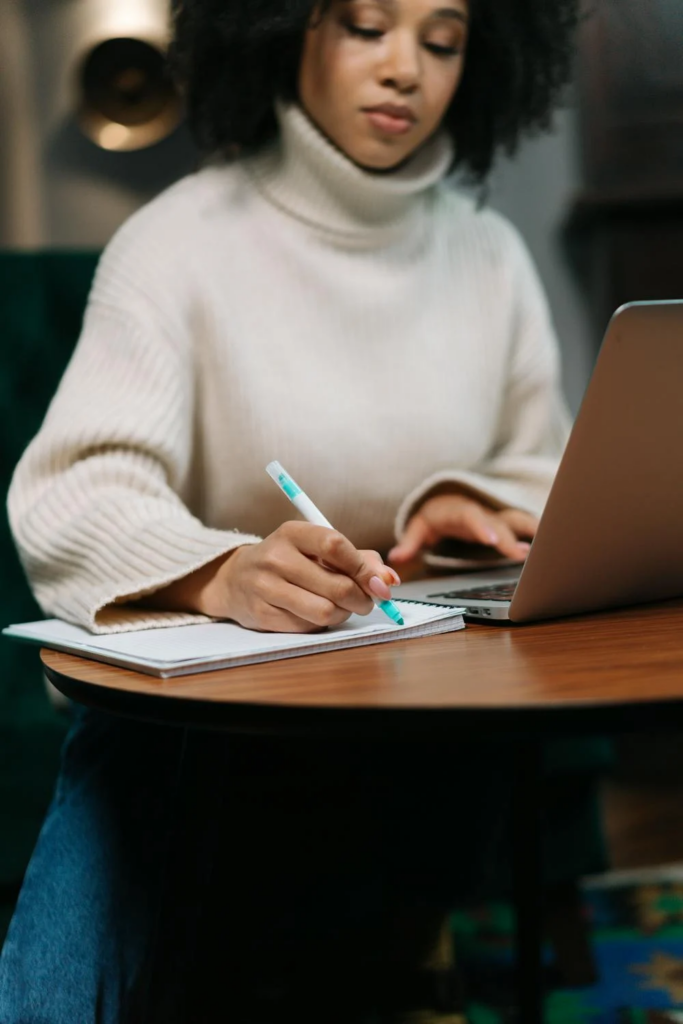 Woman Sitting and Writing in Notebook