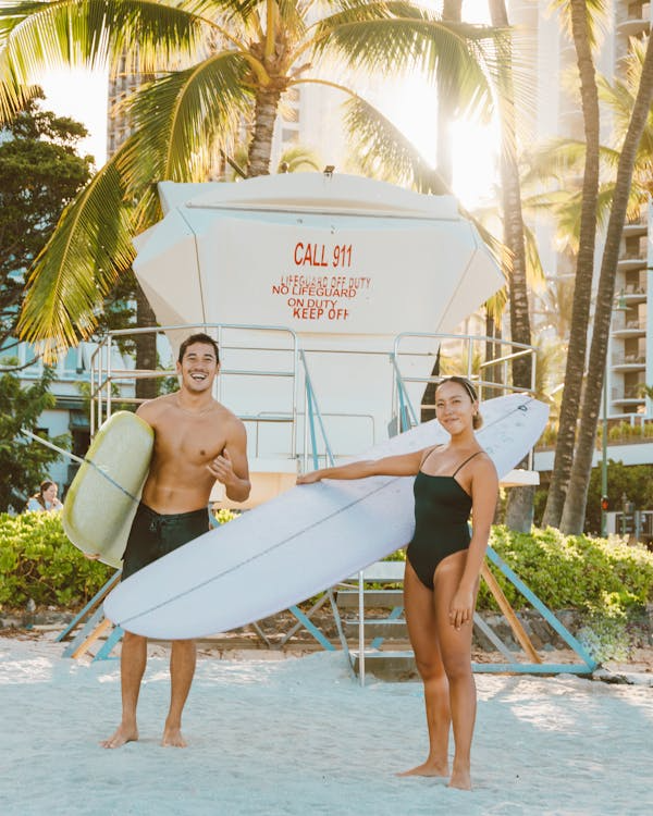 Couple Holding Surfboards