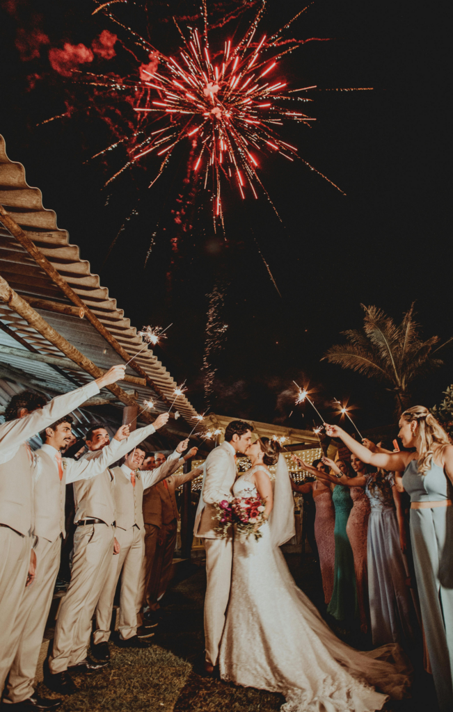 Red Fireworks Above Wedding Couple