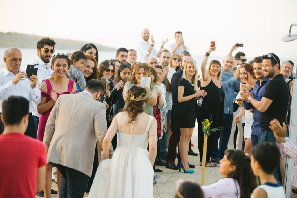 Photo of the Walking Groom and Bride and a Crowd of Wedding Guests