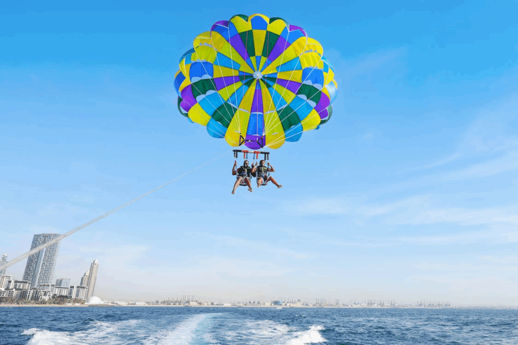 People Parachuting over Sea Shore