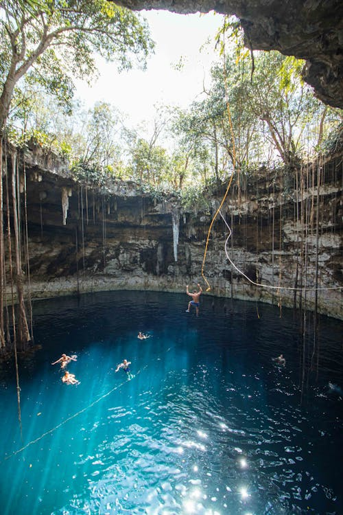 People Swimming in Cave Lake