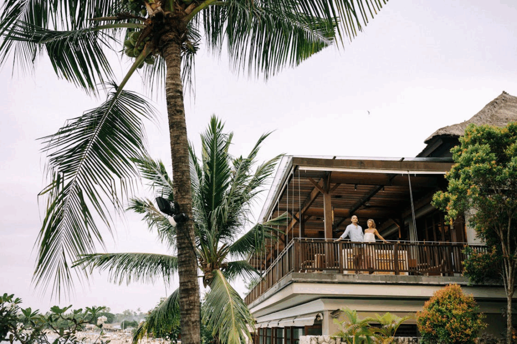 Green Palm Trees Beside a Wooden House