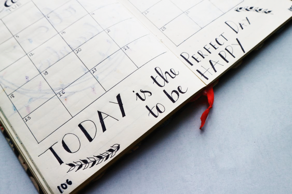 Open planner with handwritten quotes and calendar layout
